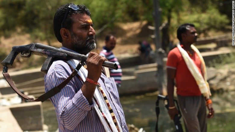 Gunmen stand alert at a water reservoir in Tikamgarh in the central Indian state of Madhya Pradesh on April 27, 2016. Armed men have been securing the Barighat dam against water thefts.
