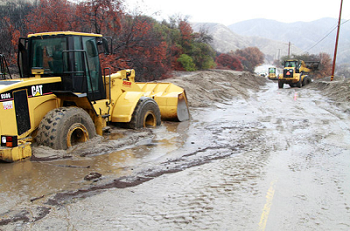 Earth movers push mudslide off Southern California roads