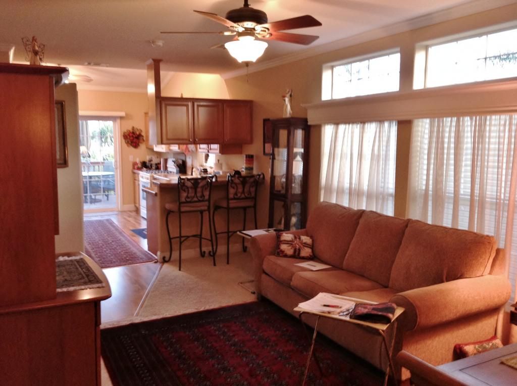 cozy living room, kitchen and desk out the glass door living room, kitchen, deck, breakfast, dining, ceiling fan, windows
